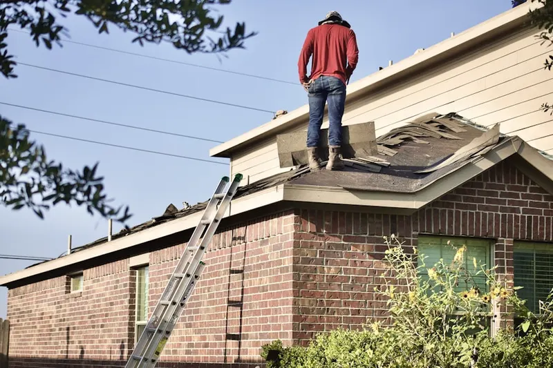 Professional roofer working on a residential roof in Bigfork